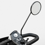 Round black rear view mirror on a long stem mounted to a mobility scooter delta tiller