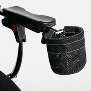 Black mesh cup holder attached beside a Jazzy Carbon power chair armrest